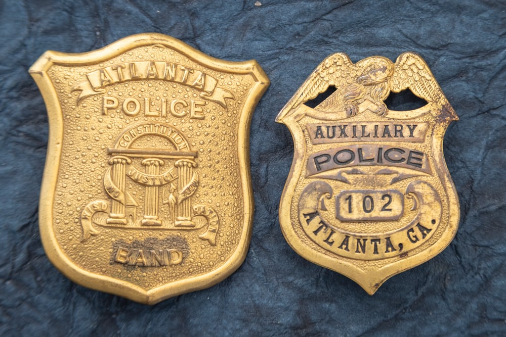 This lot consists of two Badges to include: (1) Beautiful vintage gold tone Shield Badge marked (1 of 2)