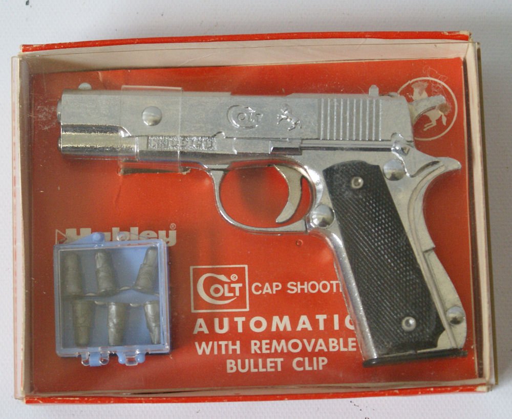 Vintage 1960 Hubley #242 Colt Automatic Cap Gun in: Vintage 1960 Hubley #242 Colt Automatic Cap Gun in original box including container with 6 bullets. Single shot, miniature, chrome, black grips, removable bullets and clip. Box measures 4-3/4" long. I
