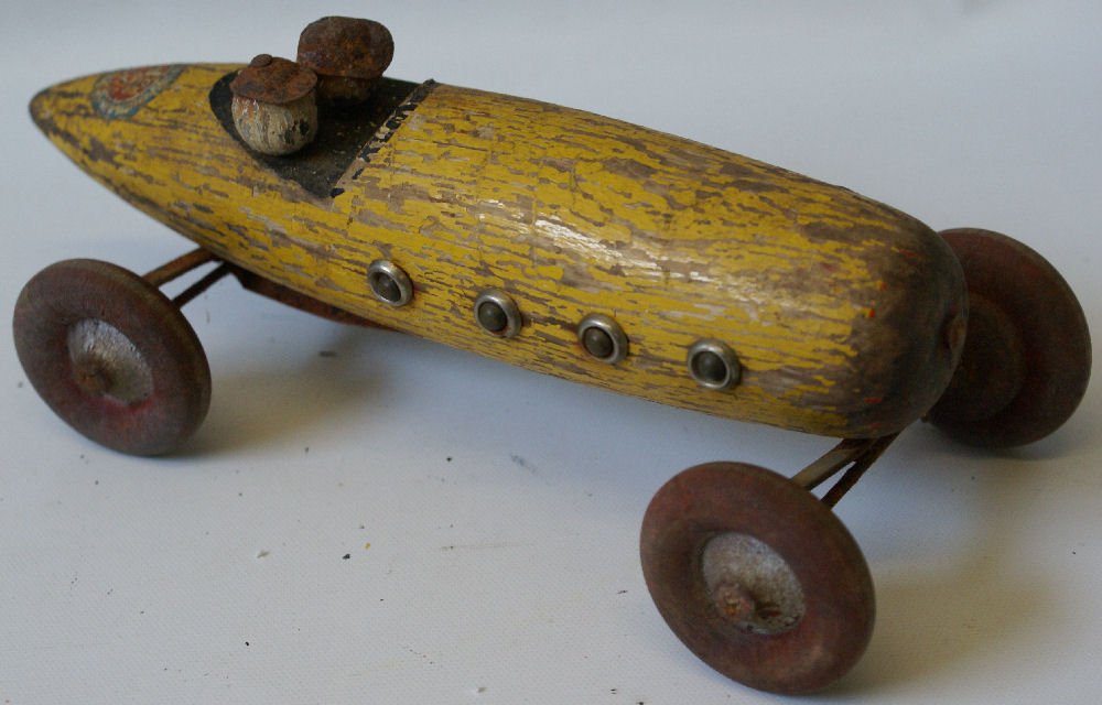 RARE Vintage 1920's Ted Toyler Wooden Noisemaker Race: Vintage 1920's Ted Toyler Wooden Noisemaker Race Car, made in Bedford MA. Fair condition. Good piece to restore.