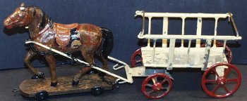 Late Teens Vintage Wood Composition Horse Drawn Tin: Late Teens Vintage Wood Composition Horse Drawn Tin Plate Farm Wagon, made in Germany. Measures 10-1/4" long. Has paint flaking on the wagon. Overall very good condition and complete.