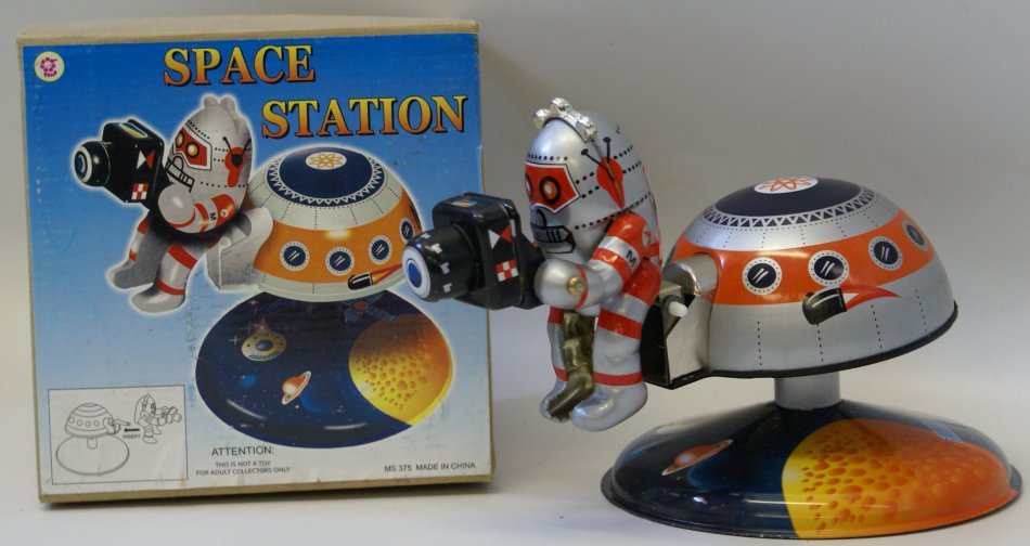 Tin Litho Windup SPACE STATION Rotating Astronaut: Tin Lithographed Wind up SPACE STATION Rotating Astronaut Robot Space Toy with key, 5-1/4" diameter base, mint in original box, made in China. Unused and not displayed. Great addition for your tin win