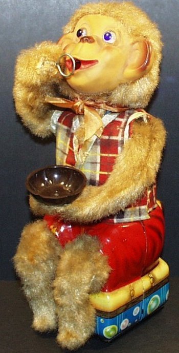 Vintage ORIGINAL Alps 1950's Battery Operated BUBBLE: Vintage original Alps 1950's battery operated Bubble Blowing Monkey. The monkey's eyes light up and he puts his hand into the cup and raises it to blow bubbles. Nice clean battery box and tin plate li