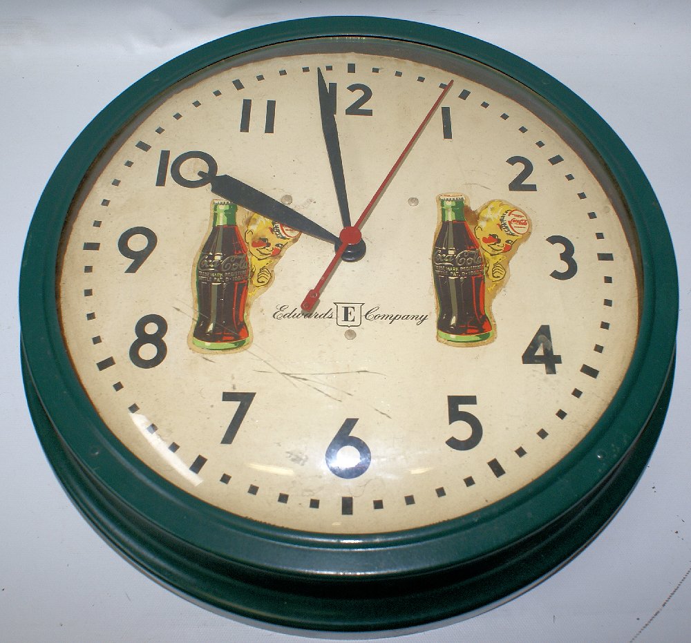 Vintage Coca Cola Round Metal & Domed Glass Wall Clock: Vintage Coca Cola Round Metal & Glass Wall Clock by Edwards Co. 13-1/2" diameter and appx. 3" deep. Has a metal base and domed glass front. It has 2 vintage Coca Cola water transfer decals on it. Edwa