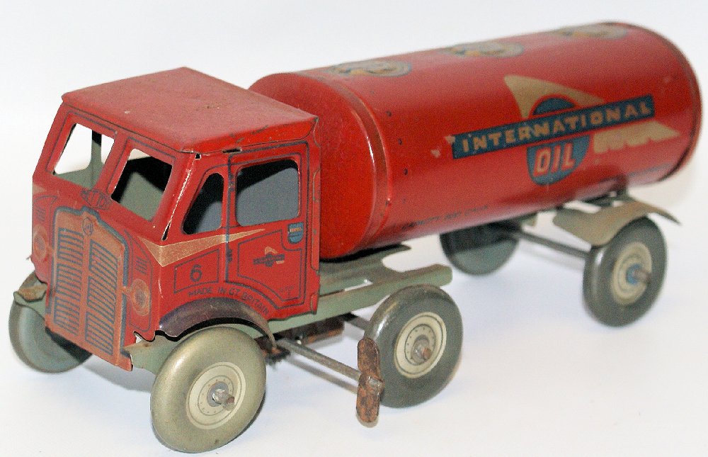 RARE Vintage METTOY Tin Windup International Oil Tanker: ULTRA RARE Vintage 1950's Tin Lithographed Clockwork Wind-up International Oil Tanker Truck by Mettoy, Great Britain. This is the scarce version, red with silver trim and grey chassis. Tank truck meas