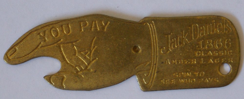 Vintage Jack Daniels "Spin to Guess Who Pays" Brass: Vintage Jack Daniels "Spin to Guess Who Pays" Brass Game Spinner / Bottle Opener. Jack Daniels Whiskey advertising, the 1866 classic amber lager. Has a hole in it so that you can use it as a keychain