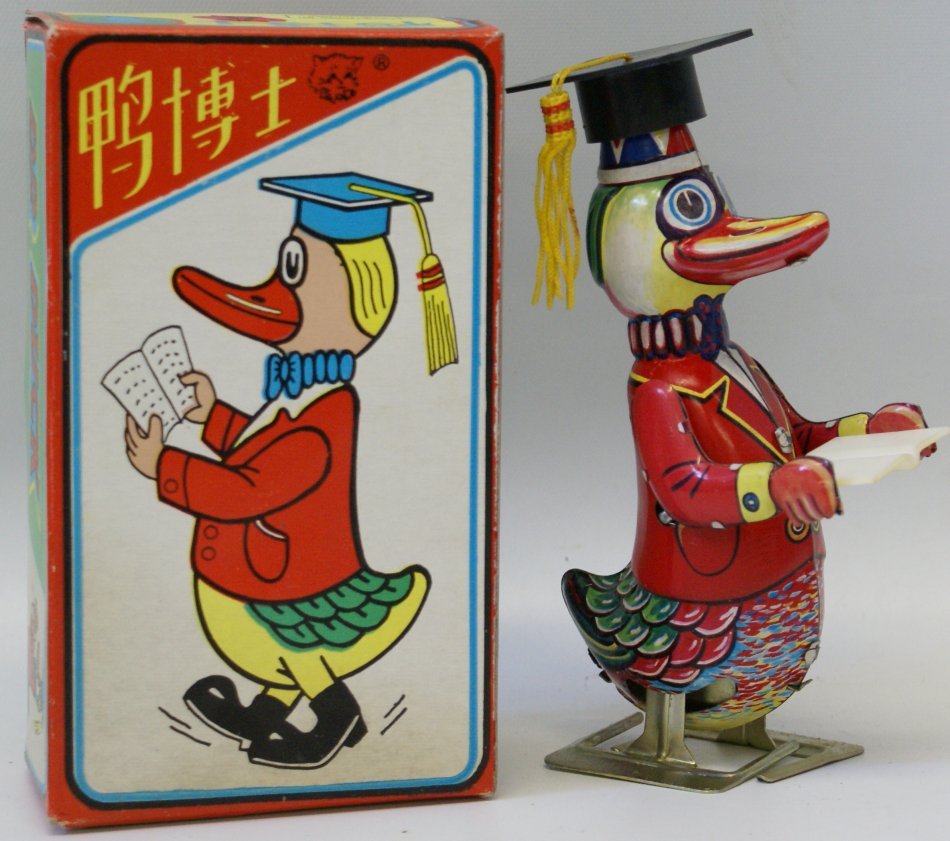 Tin Windup DR DUCK w/ Graduation Cap and Book, mint: Tin Lithographed Wind up DR DUCK walking with book in graduation cap with key, 6-1/2" tall, mint in original box, made in China. Unused and not displayed. Perfect addition to your windup tin toy colle