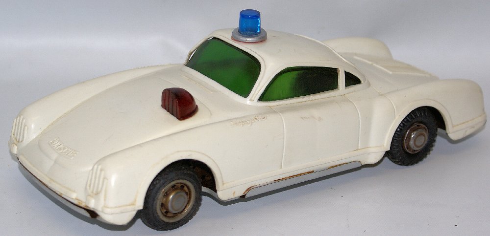 RARE Friction Drive PORSCHE SPYDER with search light &: ULTRA RARE Vintage Friction Drive PORSCHE SPYDER with search light & roof light, tin bottom, plastic body. Friction drive is in good working. Light on top of roof has been reattached. Some playwear. C