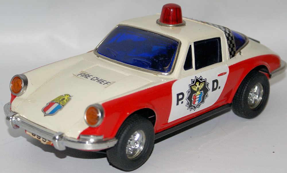 Battery Op PORSCHE Police Department Highway Patrol: Vintage Battery Operated PORSCHE Police Department Highway Patrol Squad Toy Car. Hard plastic car. License plate reads: 9951. Stickers have been placed on the hood and trunk that say: Fire Chief. Has