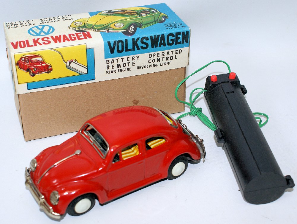 YOSHIYA Remote Control Battery Op Red Tin VW Volkswagen: Vintage YOSHIYA (KO) Japan, Remote Control Battery Operated Red Tinplate VW Volkswagen Beetle Bug 5027 Toy Car. Very hard to find VW. This is the red version. LN condition in the original box. Old sto