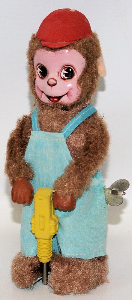 Wind-up Walking JACKHAMMER MONKEY, Japan: Vintage Wind-up Walking JACKHAMMER MONKEY, Japan. Nice working condition. When wound, the cute little fur covered monkey with tin face and red hat moves his jack hammer up and down. Measures 8" tall.