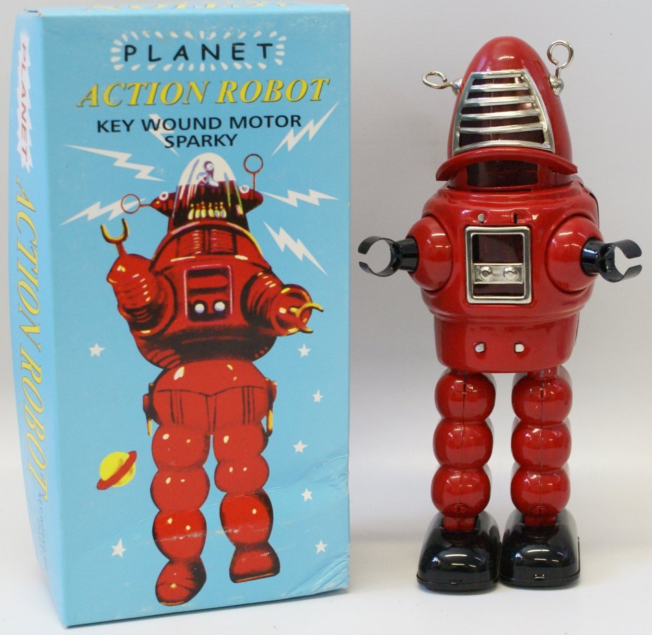 Tin Red PLANET ACTION Windup Sparking Robot: Red Tin Lithographed PLANET ACTION Wind up Robot Space Toy with key, sparky sparking action. 9" tall. Mint in the original box with inserts. This is based on the Robbie Robot from Forbidden Planet. Un