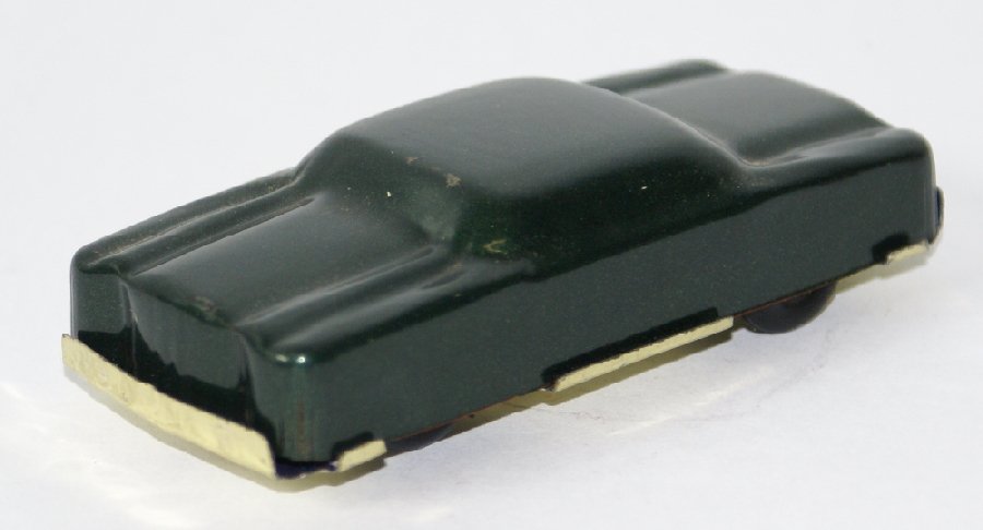 Vintage 1960's Metallic Green Tin Penny Toy Car, by: Vintage 1960's Metallic Green Tin Toy Car, by Masudaya, Japan. Toy maker mark can be seen on the inside of the bumper. An unusual little penny toy car that measures 3-1/2" long. Near mint condition. (