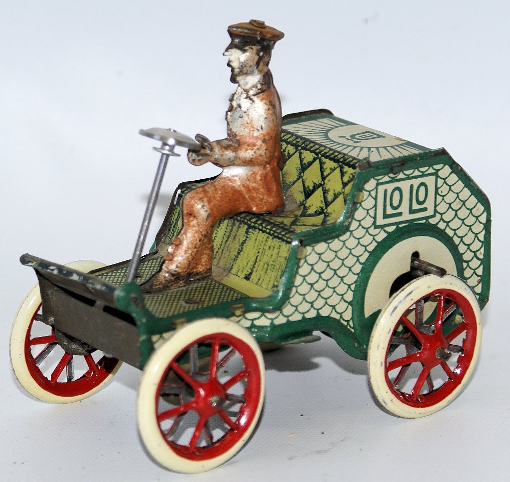 RARE Vintage Tin Lithographed Flywheel LEHMANN LOLO: RARE Vintage Tin Lithographed Flywheel LEHMANN LOLO with Original Driver. Steering wheel and wheels have been replaced. Made in Germany. Measures 4" long. Has some minor playwear.