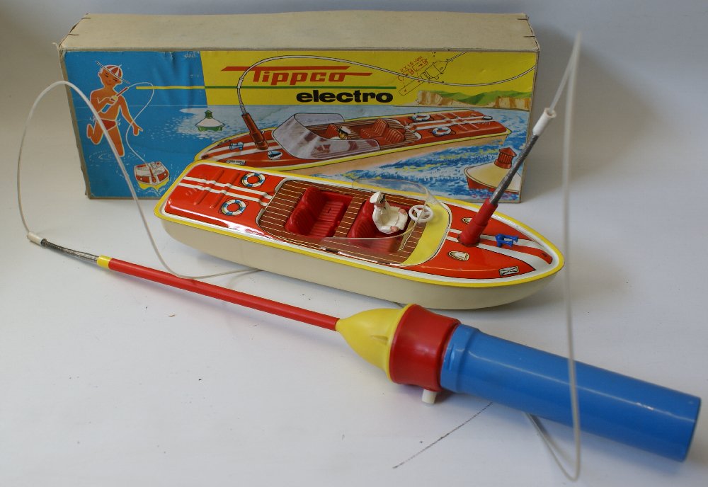 TIPPCO ELECTRO Battery Op Remote Controlled Tin Toy: Vintage TIPPCO ELECTRO Battery Operated Remote Controlled Tin Toy Boat. Boat itself is tin, and the seats, windshield, steering wheel, horn, and remote control are plastic. Overall excellent condition