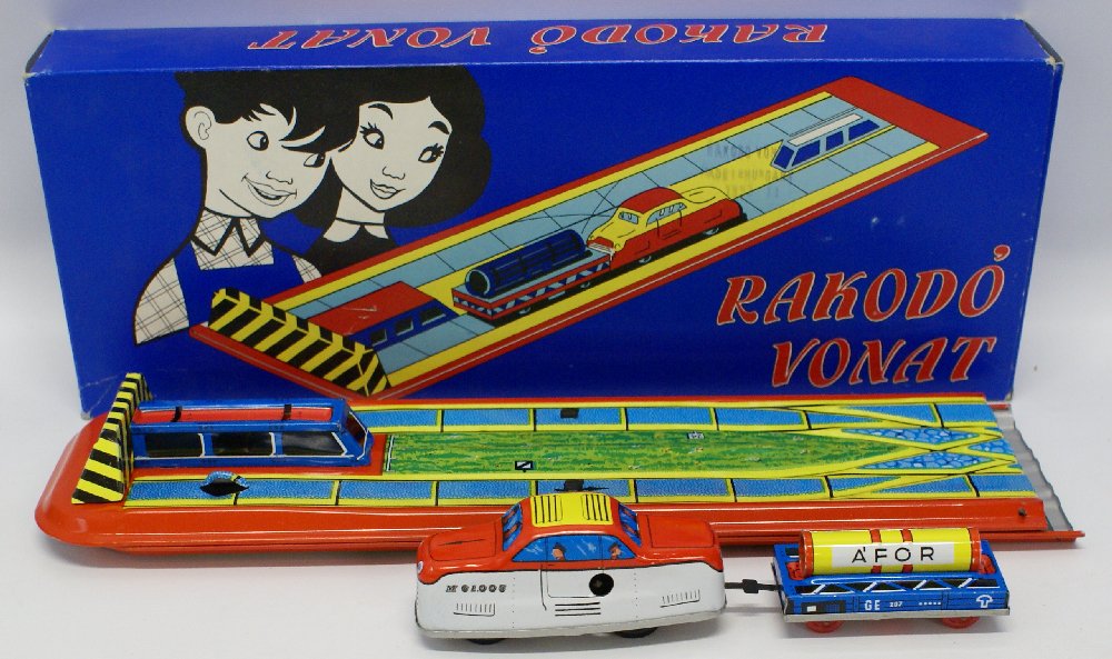 Vintage Tin Lithographed Windup RAKODO VONAT: Vintage Tin Lithographed Windup RAKODO VONAT (Hungarian) Toy Track Set in the Original Box. Comes with Fold-out tin track, wind-up shunting locomotive train car, and flat car with load. Individual tra