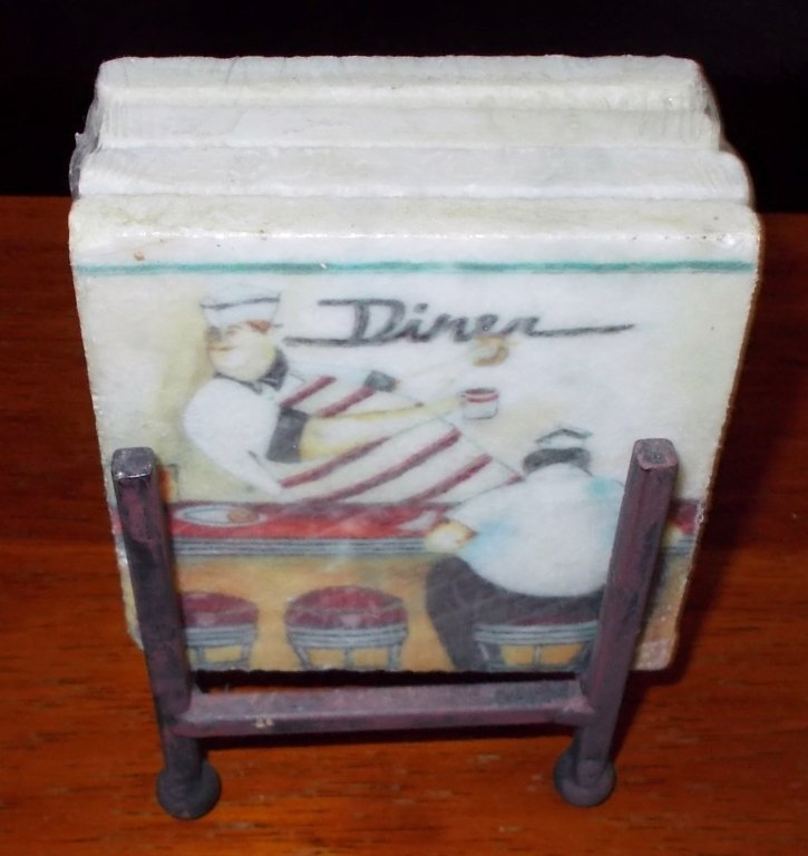 Coasters: Four unopened square marble coasters with different scenes from a diner painted on the front fit comfortably inside the iron stand that is included.