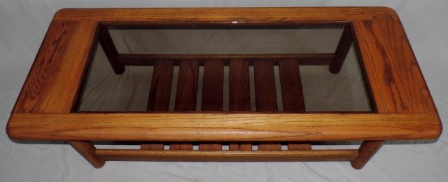 Wood and Glass Coffee Table: Smooth warm wood and glass coffee table with shelf. 54.5" X 22" X 16"