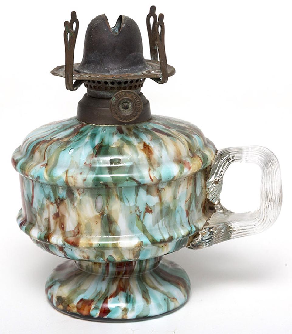 American Art Glass Finger Lamp: End of Day spatter glass with mica flecking, blown glass with applied clear reeded "C" scroll handle, flared foot, brass collar & burner. 4 1/4" diameter x 6" high.