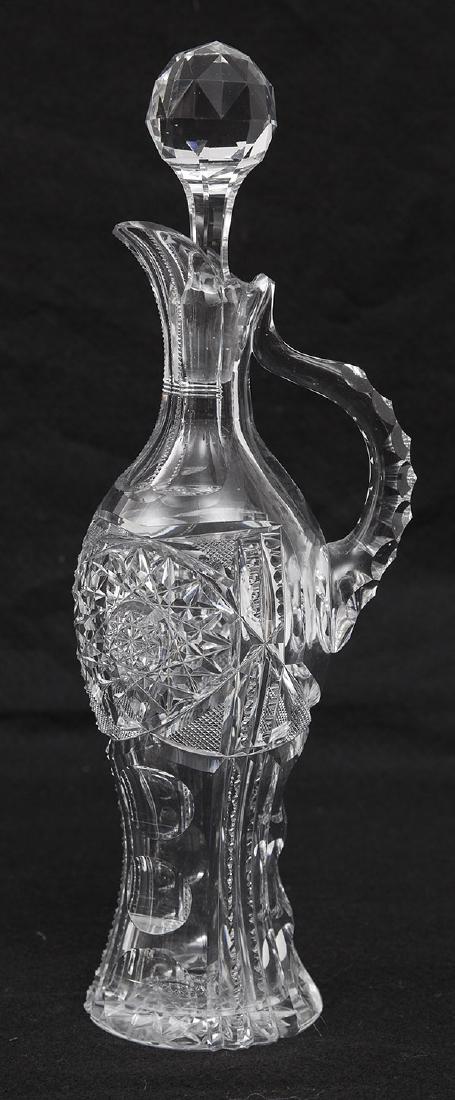American Brilliant Period Cut Glass Carafe: A lovely baluster form carafe or decanter with panel cut spout/neck with notched handle, facet cut stopper, body with nice hob-stars & nail head, over ladder and circular panels, hob-star base, 12" hi