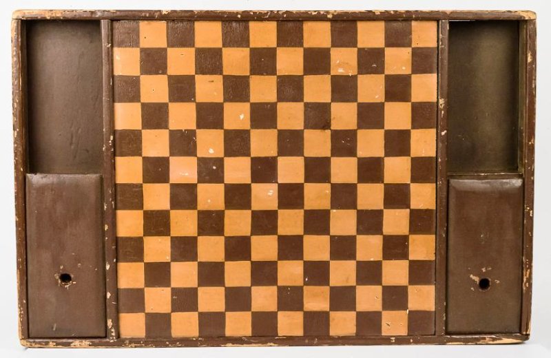 Outstanding Early Game Board: Pine in original painted finish with checkerboard top, flanked by two wells with sliding lid covering half of each in which are stored the original turned wooden checkers, or game pieces, dovetailed f