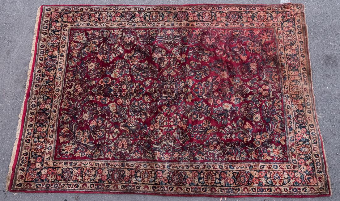 Sarouk Oriental Rug: Primary red field with stylized floral design, 73 x 106".