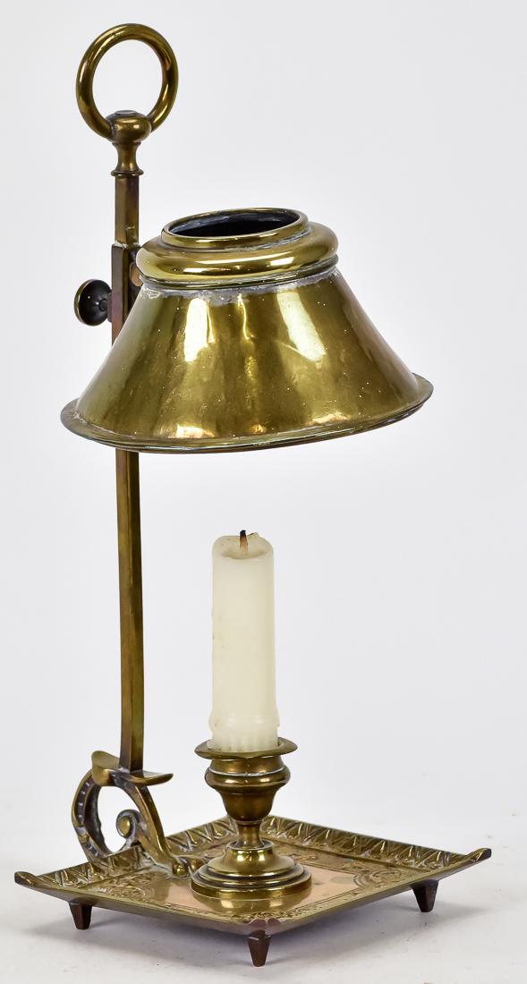 Early Brass Chamber Lamp: Candle form with adjustable brass shade, cast square base with floral scroll work decoration on four feet, finger ring handle at side with paw foot terminal, and ring handle at top, circa 1830, 6 1/4 