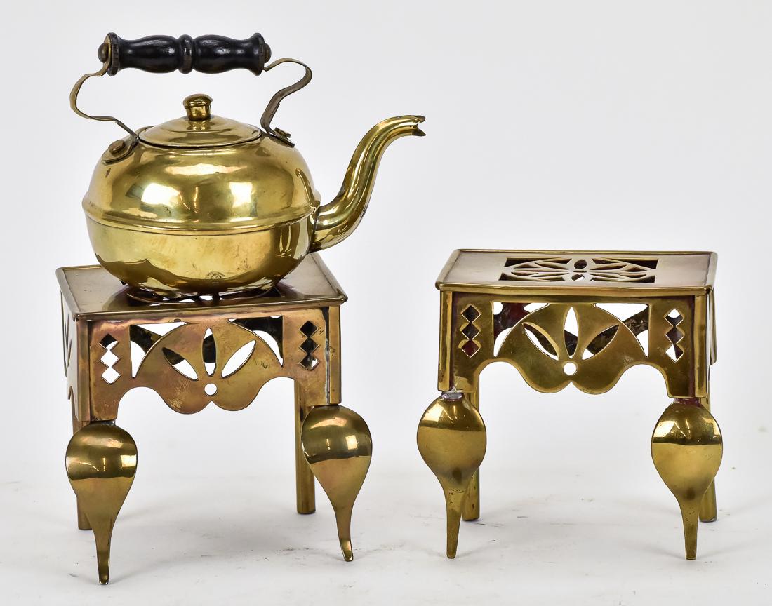 Miniature English Kettle Trivets Plus: A pair of antique brass miniature English kettle trivets with front cabriol legs and cut-out top and sides, 4 x 3 x 3 1/2" high; and a miniature brass kettle with turned wood handle and goose neck spo