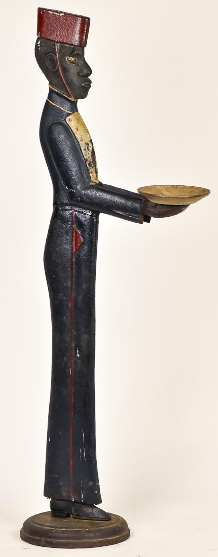 Cast Iron African American Bell-Hop Stand: Circa 1st quarter of the 20th century with unusually fine details in face and uniform in original polychrome painted finish, on round base, 38" high.