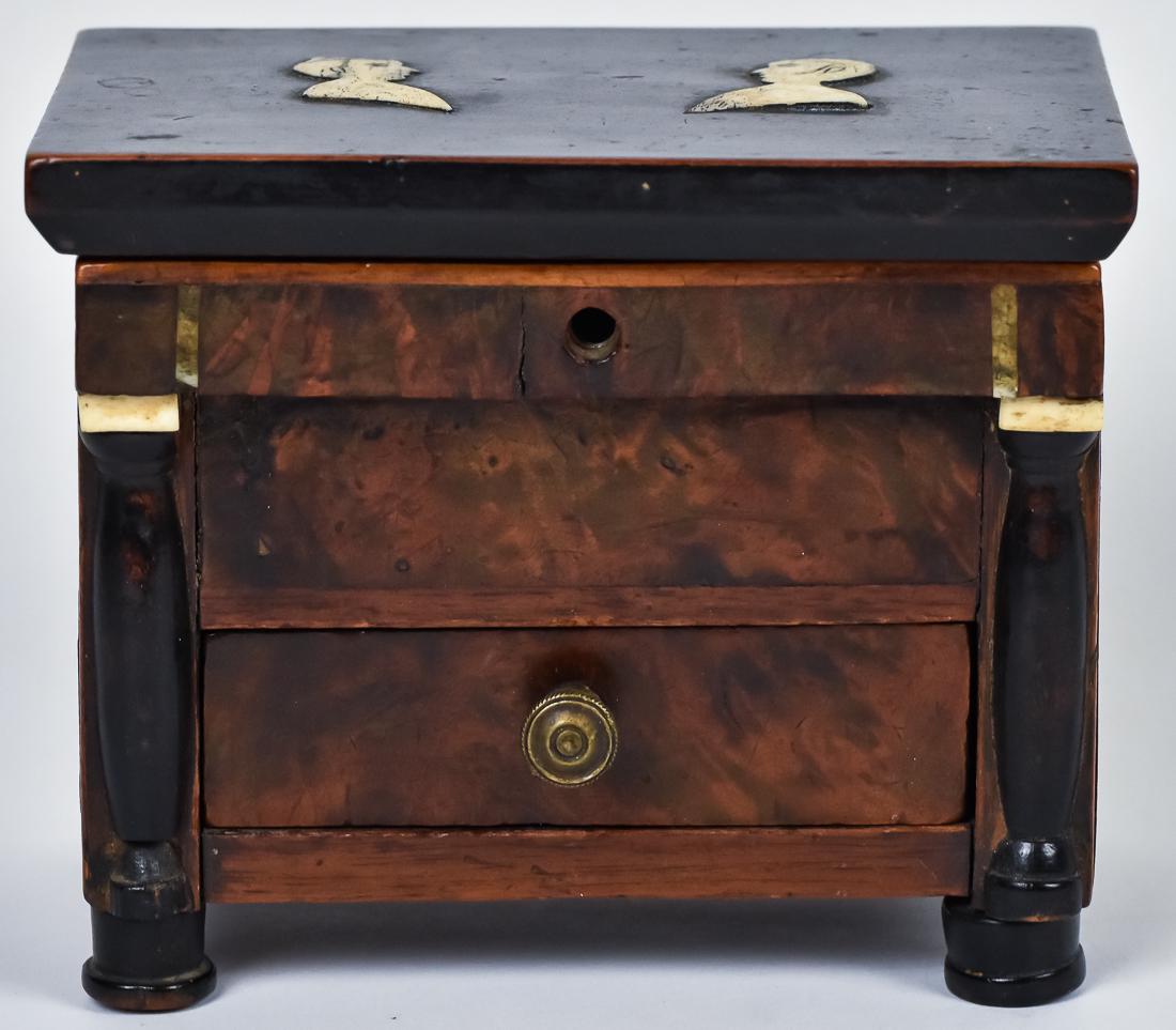 Scrimshaw Miniature Chest: Rosewood & ebony with whale bone inlaid bust of man and woman on top/lid, which lifts to reveal mirror in lid and pin cushion compartment, front with overhanging false drawer front, over two graduated
