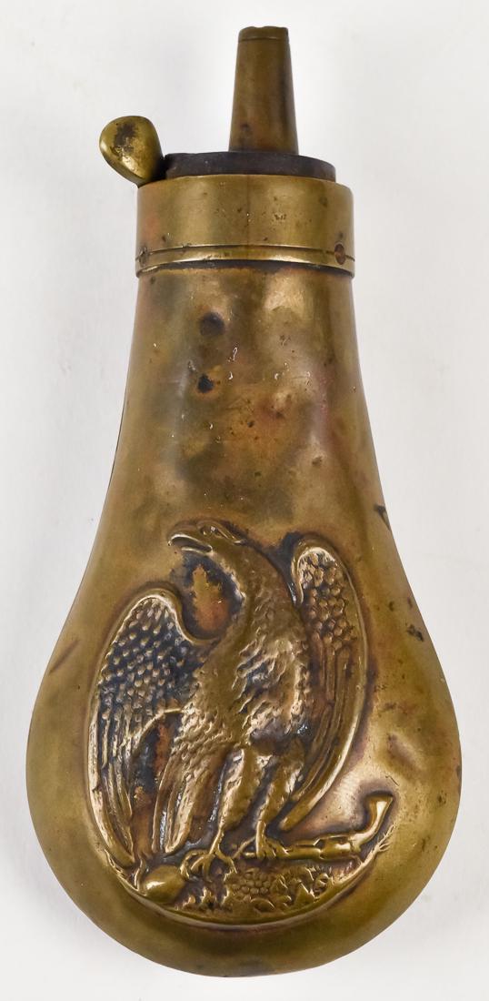 Colt Eagle Shot Flask: Brass with spread winged eagle clutching revolver and flask in talons on each side, pistol type flask, see No.806, page 353 in The Powder Flask Book by Ray Riling, 1953, 4 1/2" high.