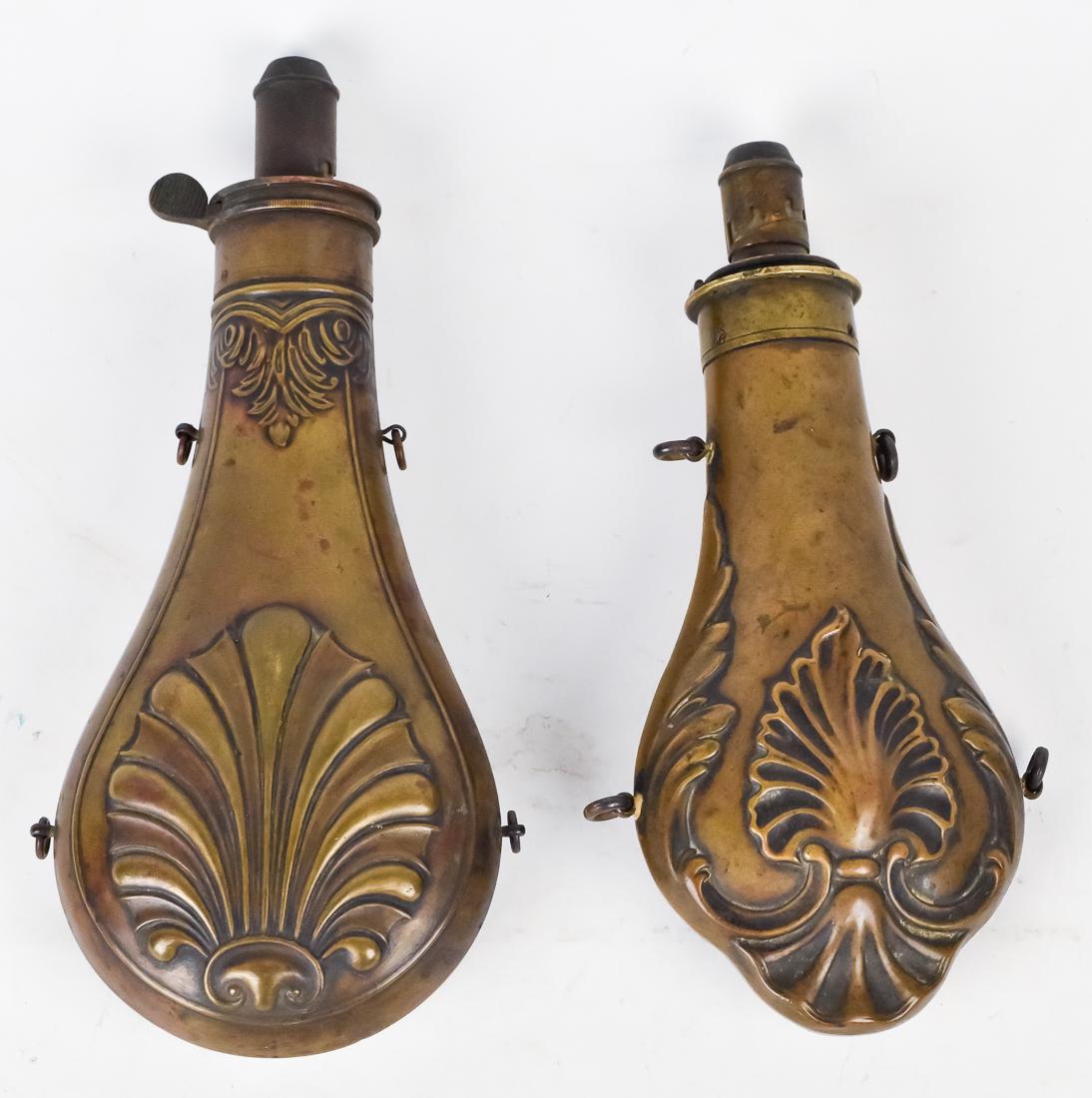 Two Shell Scroll Shot Flasks: Both brass and double sided with four ring handles, 8 & 9" long.