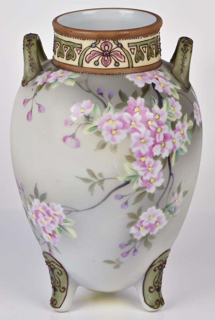 Nippon Tri-footed Vase with Floral Decoration: Double handled. M in wreath mark. 9 1/4" high. Fine condition.