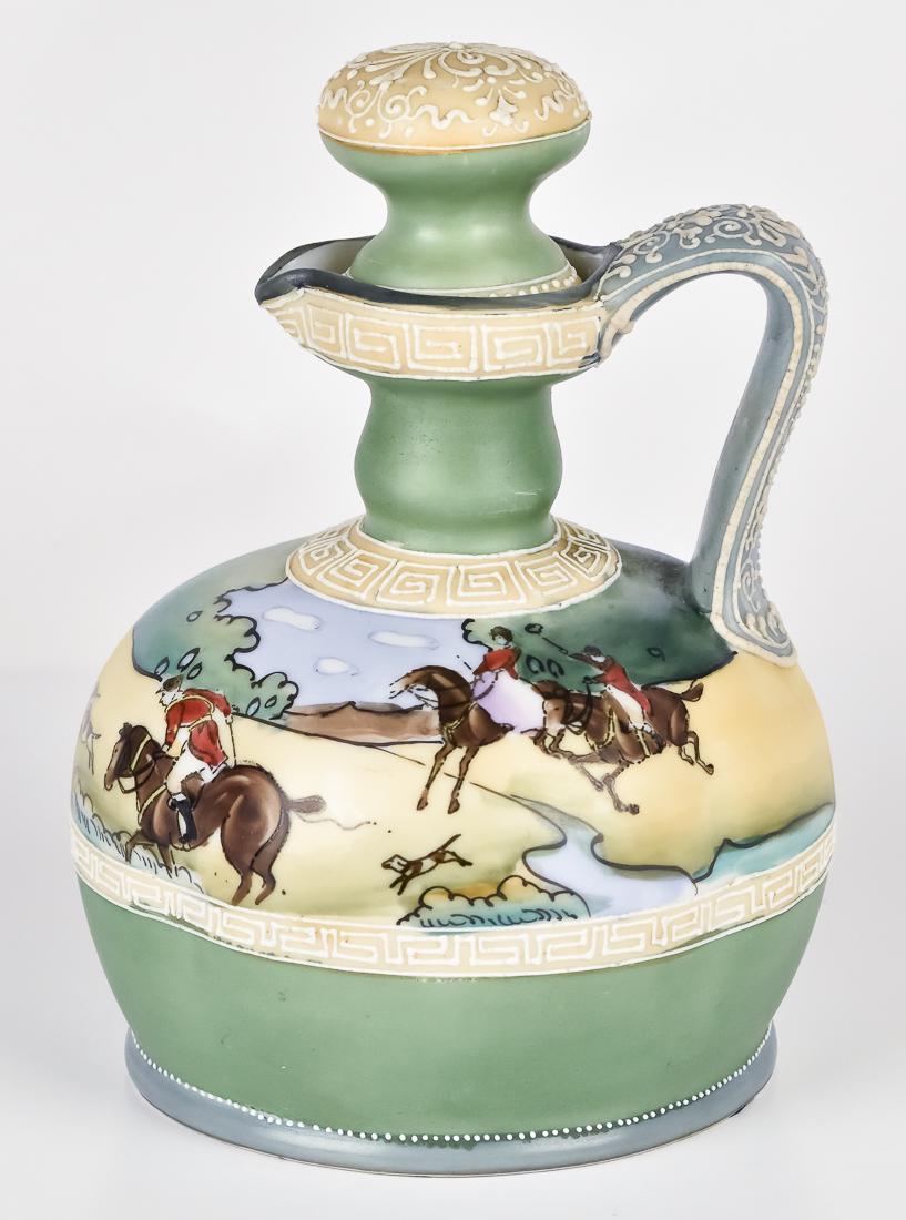 Nippon Wine Jug with Hunt Scene: Nice jug with moriage decoration and hunt scene encircling it. Blue maple leaf mark. 7 1/2" high. Fine condition.