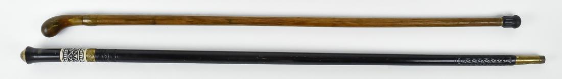 Sword Cane Plus: Lot of two, including a sword vane with brass lion mask cap on horn handle with carved bone below, brass collar which turns to opens to reveal a single edges 24 3/4" long steel blade with 3/4 length f