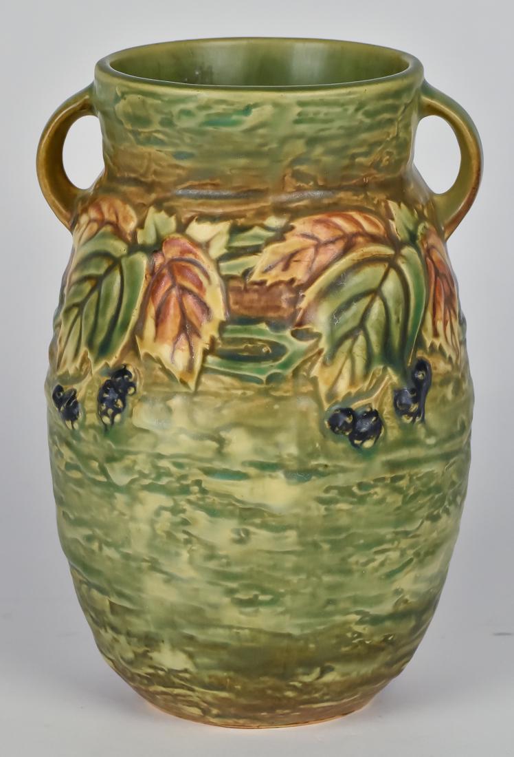 Roseville Blackberry Vase: Green with brown band in center on which the raised vining blackberry rests, two handles, unmarked, 5 1/2" diameter x 8 1/4" high. Fine.