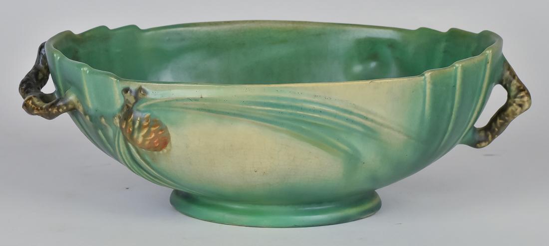 Roseville Pinecone Center Bowl: Green grounds, including one with two pronounced twig handles at shoulder with raised pine needles and cone on body, unmarked, 11 x 6 1/4 x 3 1/2" high. Fine.