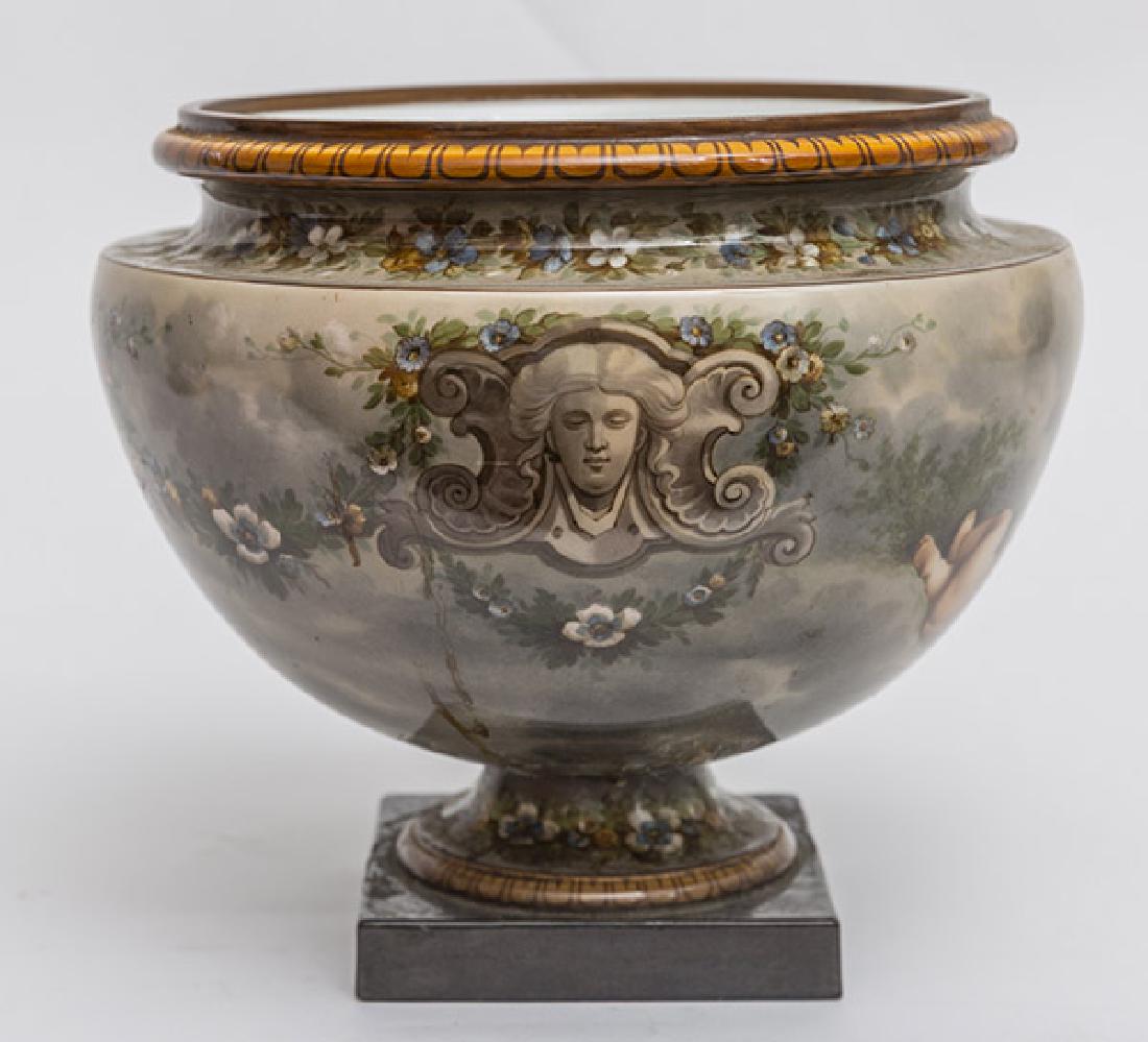 Fine KPM Urn: Beautifully painted with cherubim, architectural masks and floral garlands, two piece, bolted together, marked on base, 12" diameter x 11" high.