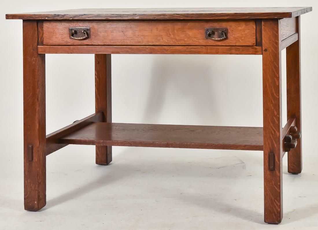 L. & J.G. Stickley No. 529 Library Table: Oak, splined top, with single drawer with hand hammered copper pulls, tenon and keyed lower shelf and mortised through construction, signed with The Work of Decal, very good original finish, few marks
