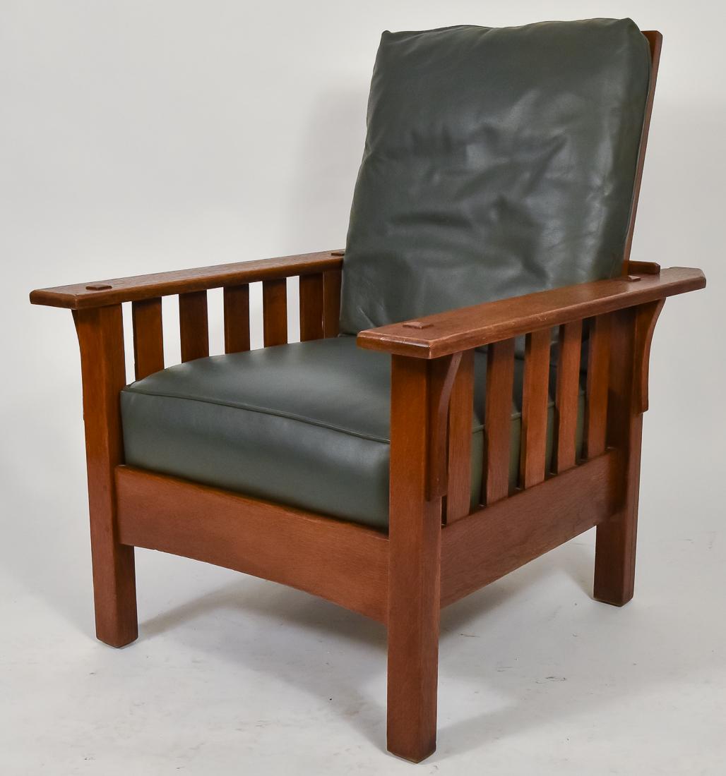 J.M. Young Morris Chair: Oak, with five slats and corbels under each arm, arched front stretcher with pinned construction, professional replaced leather cushion, very good original finish, very good condition, old replaced se