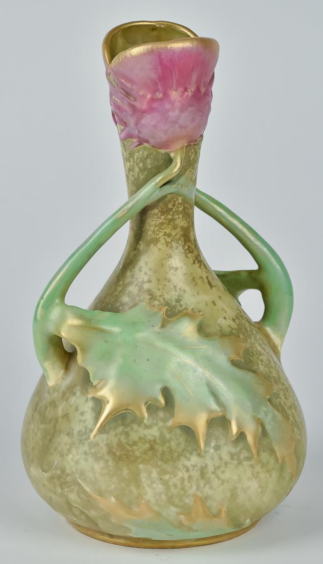 Amphora Art Pottery Vase: Arts & Crafts design with high relief molded leaves and flowers in mottled green ground with green leaves and stem handles and pink flower mouth with matt gold highlights, stamped Amphora Austria with