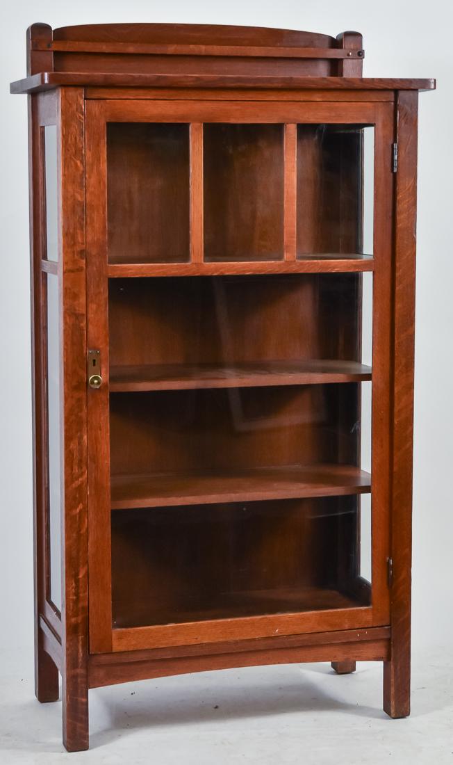 Limbert Single Door China Cabinet: Oak, with three small panes over one large, adjustable shelves and arched plate rail & apron, original brass hardware, signed with branded mark on back, excellent original finish, excellent condition,