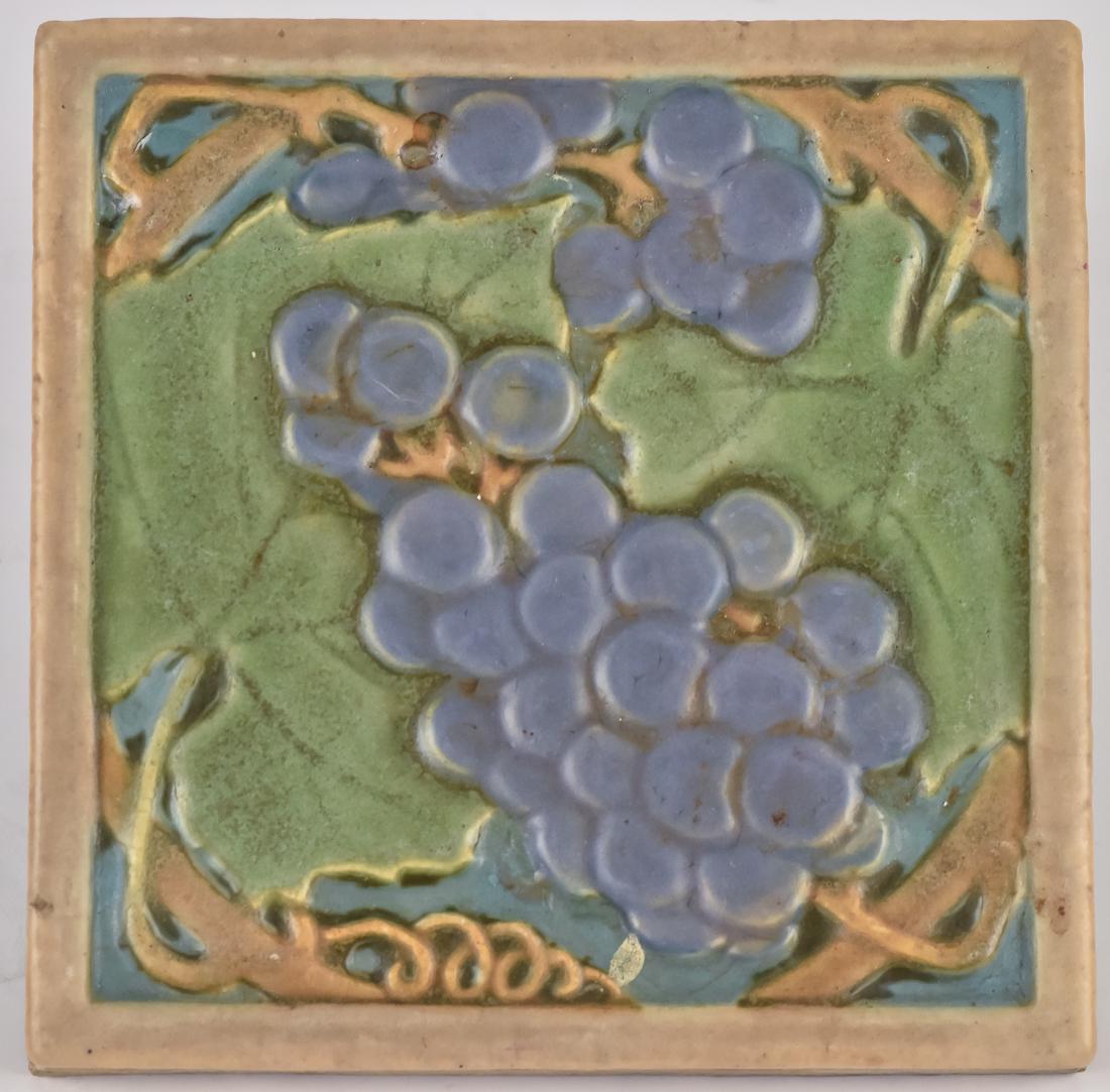 Rookwood Faience Tile: Polychrome painted in matt glaze with hanging grapes in relief, " square, back with glued green felt cover, 6"x 6".