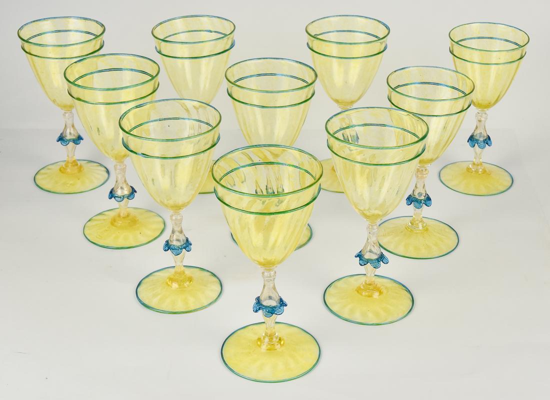 Venetian Glass Wines: Matching lot 166a . Set of ten, all hand blown with swirled ribbed bowls and bases in yellow, clear air-trap stems with applied blue floral, matching banding on bowl and foot, all shot through with go