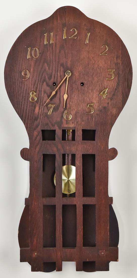 Arts & Crafts Oak Wall Clock: Circa 1910 with balloon shape, tacked on brass Arabic numerals, scroll cut drop with hanging brass pendulum. Brass spring driven time & strike 8-day movement, case in original old varnish finish, 14 1