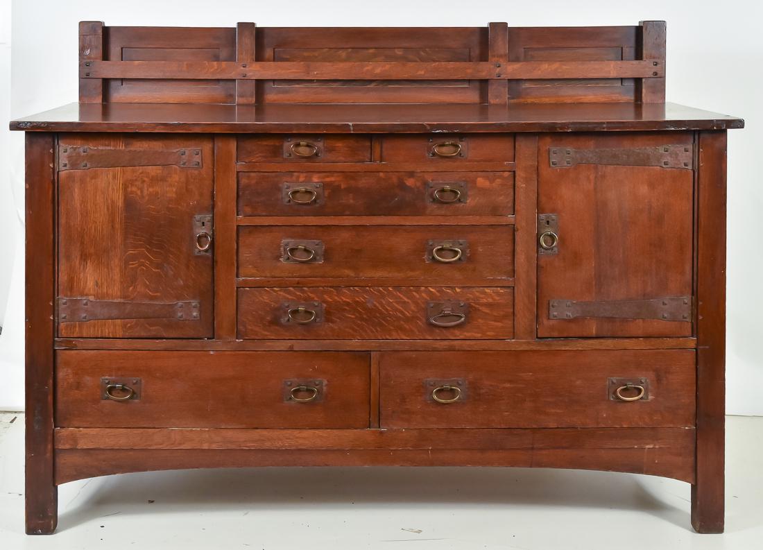 Charles Stickley Sideboard: With plate rail backsplash, and two doors with copper strap hinges between five drawers and two drawers below, all with hand hammered copper hardware. Very good original finish with very slight overco