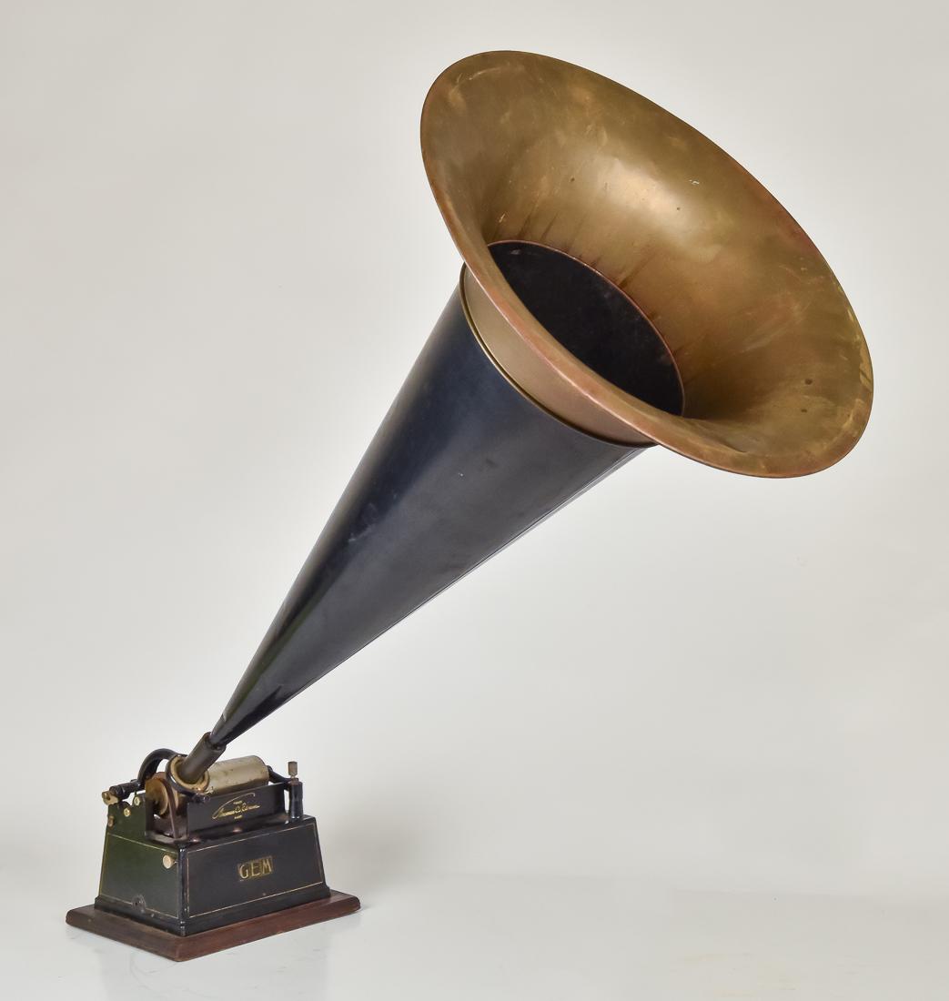 Edison Gem Cylinder Phonograph: On oak base in original black painted finish with original decals, crank key and horn, 16 3/4" diameter x 30" long, phonograph is 7 1/4 x 9 1/2 x 7 1/4" high, less horn.