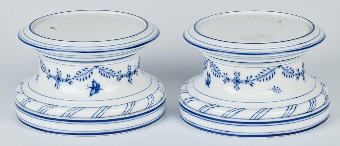 Pair Of KPM Porcelain Pedestals: Blue underglaze with floral swags and butterflies, blue underglaze crowned scepter mark on base, 7" diameter x 4 1/2" high.