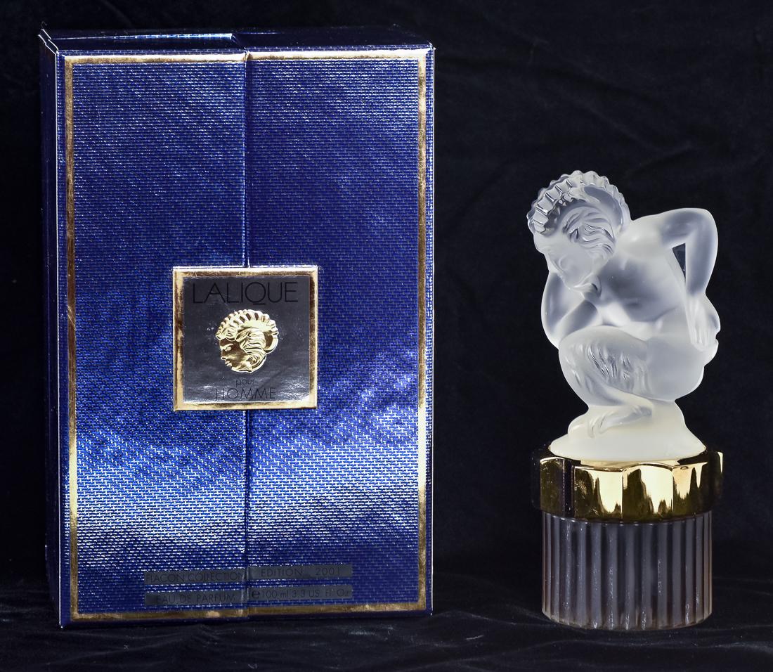 Lalique Perfume in Case: Labeled Lalique Pour Homme Flacon Collection Edition 2001 Eau De Parfum, with frosted Greek God Pan lid and full fluted bottle with printed label on base and gold mount, includes atomizer, bottle is 8