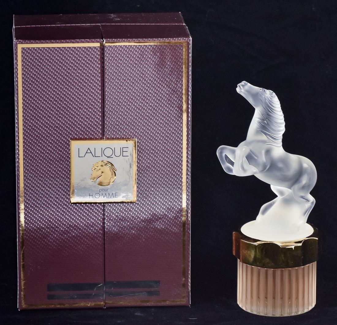 Lalique Perfume in Case: Labeled Lalique Pour Homme Flacon Collection Edition 2002 Eau De Parfum, with frosted rearing horse lid and full fluted bottle with printed label on base and gold mount, includes atomizer, bottle is 8