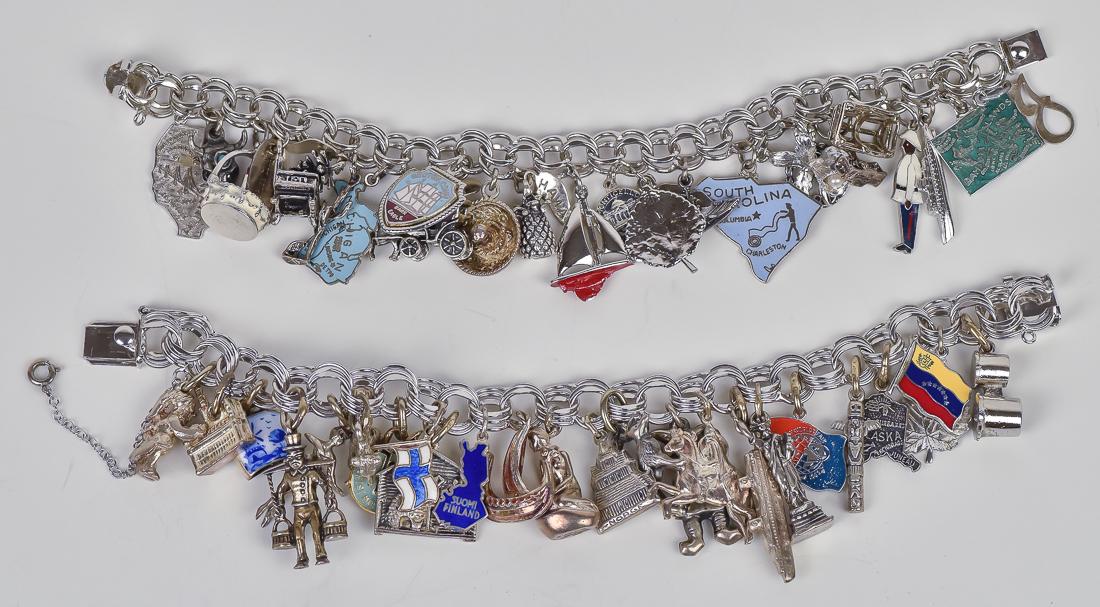 Two Sterling Silver Charm Bracelets: First has 24 charms, some enameled, including both figural and medallion type, ships, people, sail boats, birthday cake, pineapple, horse drawn carriage, sombrero, wood stove, aircrft carrier, pinecon